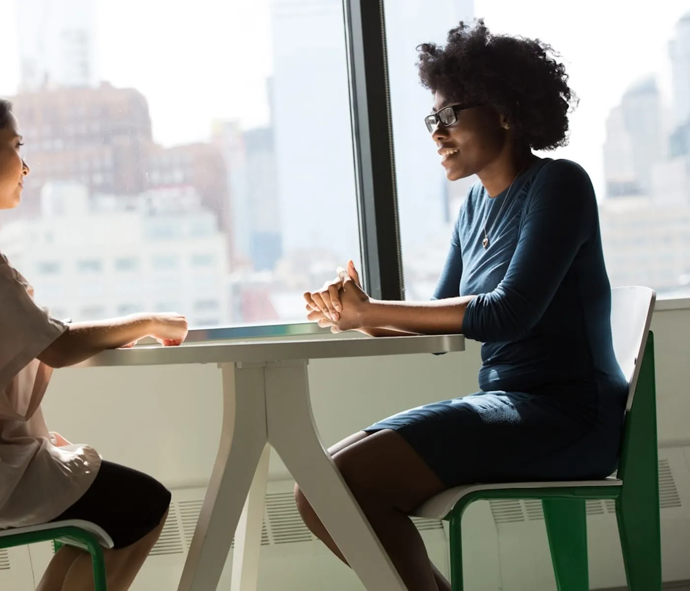 An AI consultant and a business owner talking one-to-one at a table